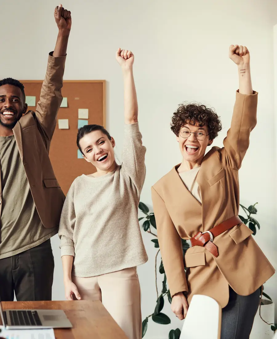 Happy business team celebrating in a bright office